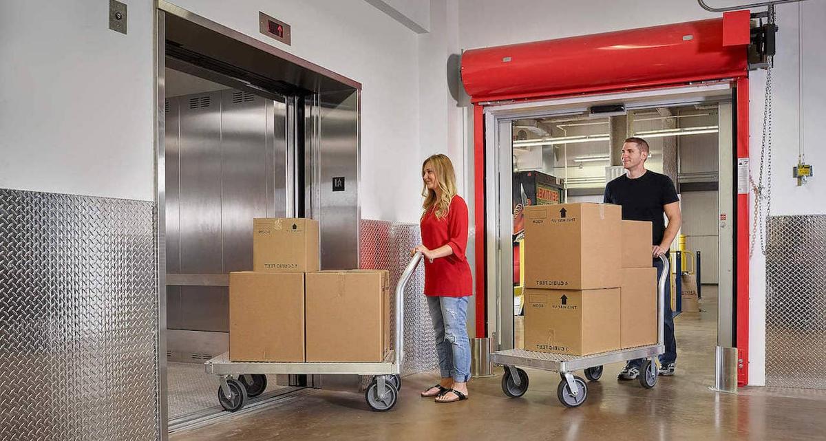 couple Loading an elevator-self-storage